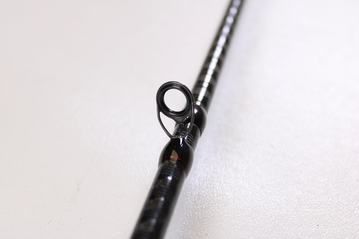 Close-up of a Shimano Zodias ZDC610MA 6'10" Medium Used Casting Rod in excellent condition, focusing on a line guide against a white background—ideal for trading in gear at the Nation's Best Rod and Reel Trade-In Program for store credit.