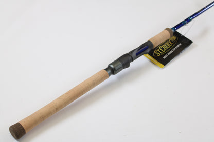 A close-up of the St. Croix Legend Tournament Inshore ITLS76MF 7'6" Medium Used Spinning Rod in mint condition with a cork handle, blue finish, and black reel seat—ideal for those considering our rod and reel trade-in program.