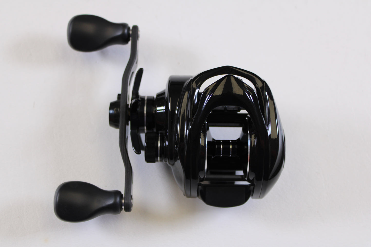 The Kistler Series 1 7.3:1 LH Used Casting Reel (black, dual handle grips) in excellent condition—perfect for anglers seeking quality pre-owned gear or wanting store credit via our rod and reel trade-in program.