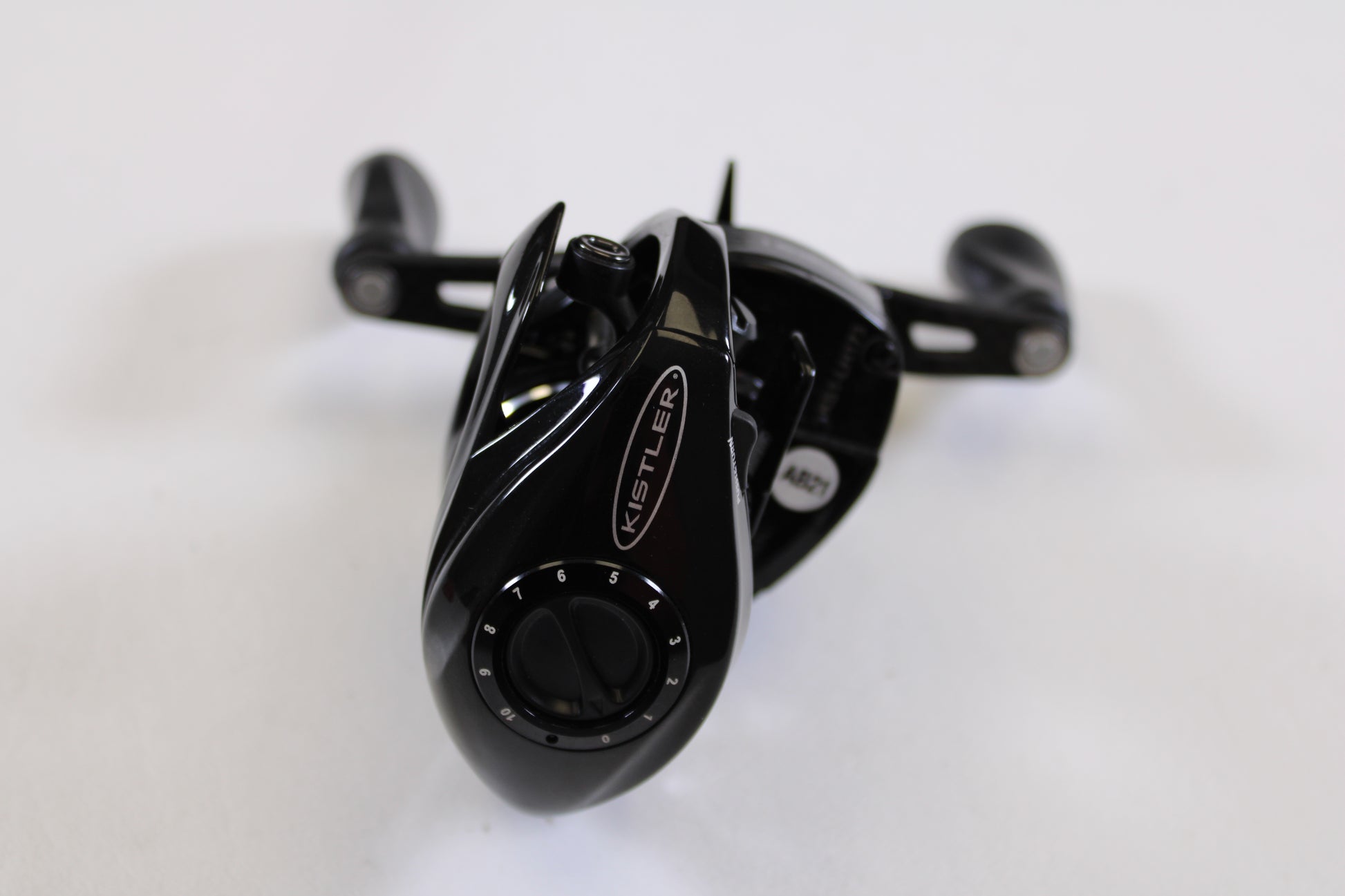 A close-up of a Kistler Series 1 7.3:1 LH used casting reel in excellent condition, featuring a numbered dial and two handles—ideal for upgrading your fishing gear or exploring our rod and reel trade-in program.