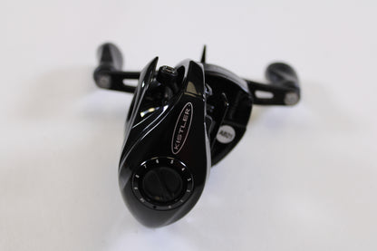 A close-up of a Kistler Series 1 7.3:1 LH used casting reel in excellent condition, featuring a numbered dial and two handles—ideal for upgrading your fishing gear or exploring our rod and reel trade-in program.