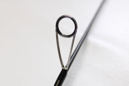 Close-up of the eyelet and metal frame on the Raid Japan Gladiator Maximum GX-59XLS-AS Solid Maxx XL 5'9" Extra Light Used Spinning Rod—shown in mint condition, perfect for our Rod and Reel Trade-In Program.