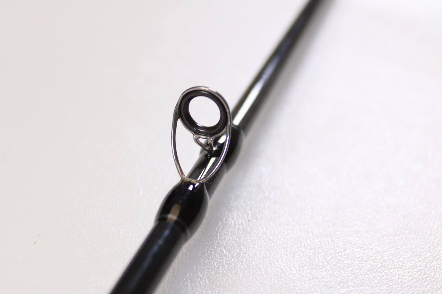 Close-up of the guide ring on a Lamiglas X11 Graphite Handle LX86MCGH 8'6" Medium 2 Piece Used Casting Rod in excellent condition—ideal for anglers seeking quality pre-owned Lamiglas gear.