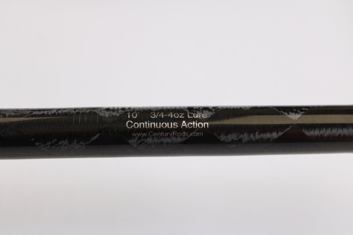 Close-up of a Century SurfMachine SM10L 10'0" used spinning rod (30/70 split, 2-piece) in excellent condition, showing model details on its black surface—ideal for our Rod and Reel Trade-In Program.