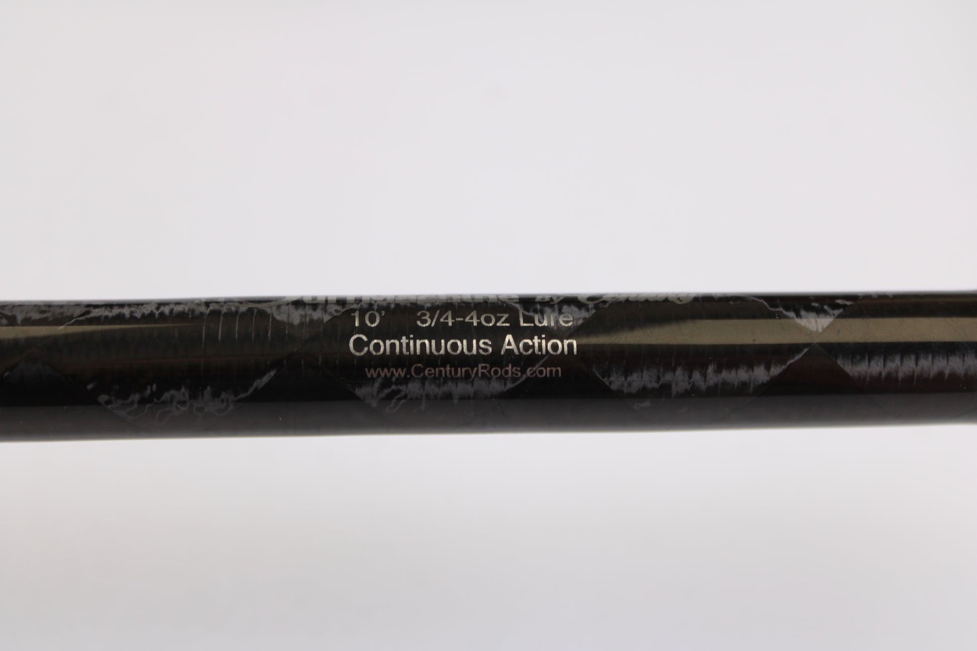 Close-up of a Century SurfMachine SM10L 10'0" used spinning rod (30/70 split, 2-piece) in excellent condition, showing model details on its black surface—ideal for our Rod and Reel Trade-In Program.