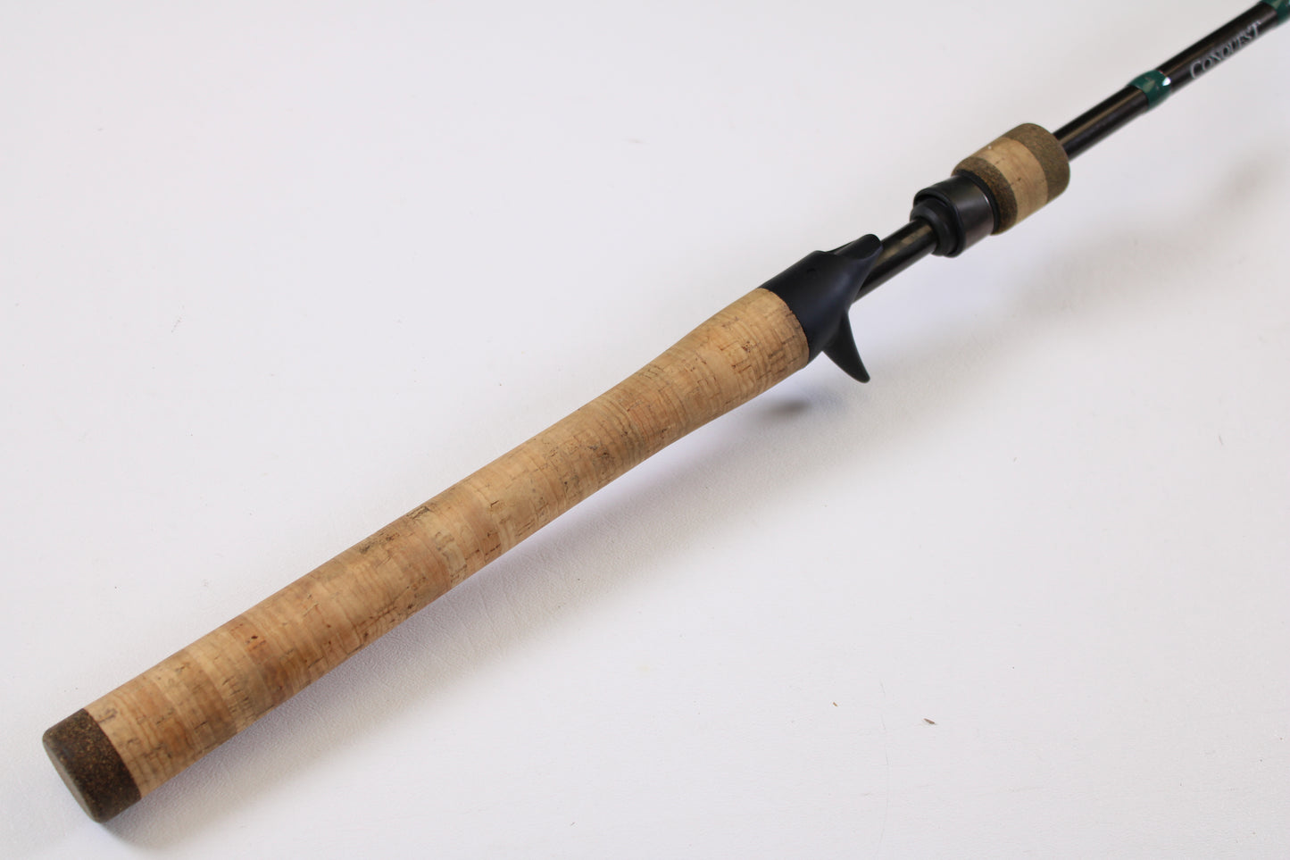 A close-up of a G. Loomis Conquest CNQ 783C MBR 6'6" Medium Heavy Casting Rod handle, in excellent used condition—trade in your gear for store credit or upgrade with our Rod and Reel Trade-In Program.