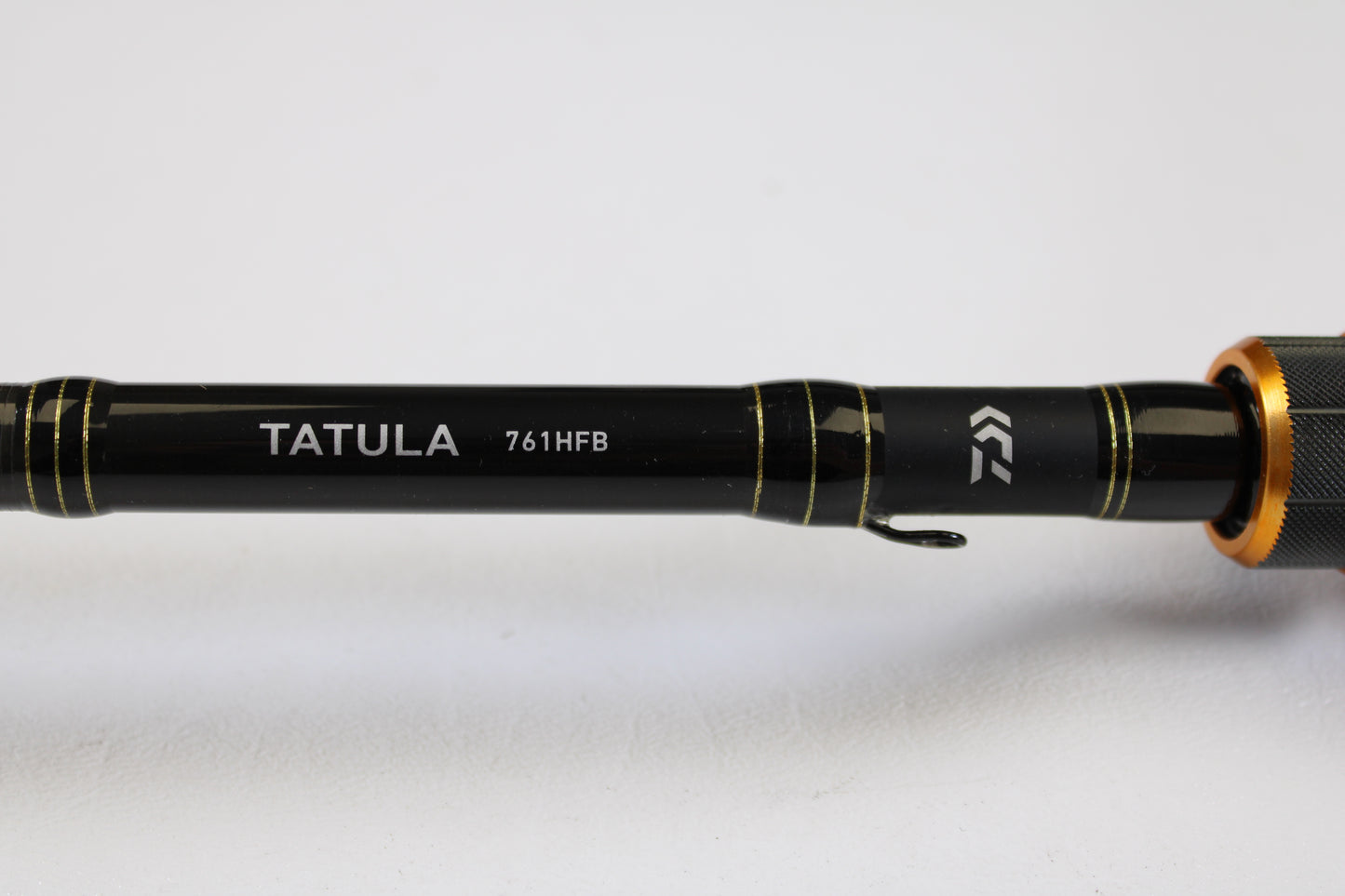 Close-up of a Daiwa Tatula TAT761HFB 7'6" Heavy Used Casting Rod in excellent condition, with logo detail on a plain white background—ideal for anglers upgrading through our Trade-In Program or earning store credit for used gear.