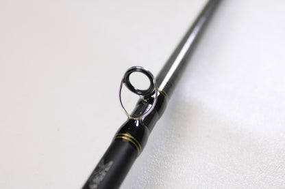 Close-up of the Daiwa Tatula TAT761HFB 7'6" Heavy Used Casting Rod in excellent condition, highlighting its guide ring with metallic finish and black accents—upgrade today with our Rod and Reel Trade-In Program for store credit.