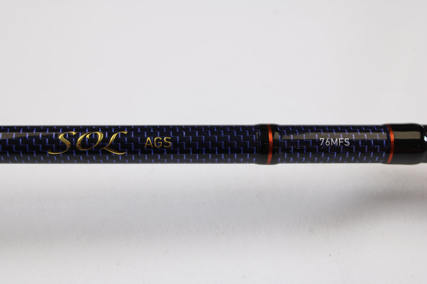 Close-up of a Daiwa Sol AGS SOLAGS76MFS 7'6" Medium Used Spinning Rod in excellent condition, featuring carbon fiber pattern and red accents—eligible for our Rod and Reel Trade-In Program for store credit on used gear.