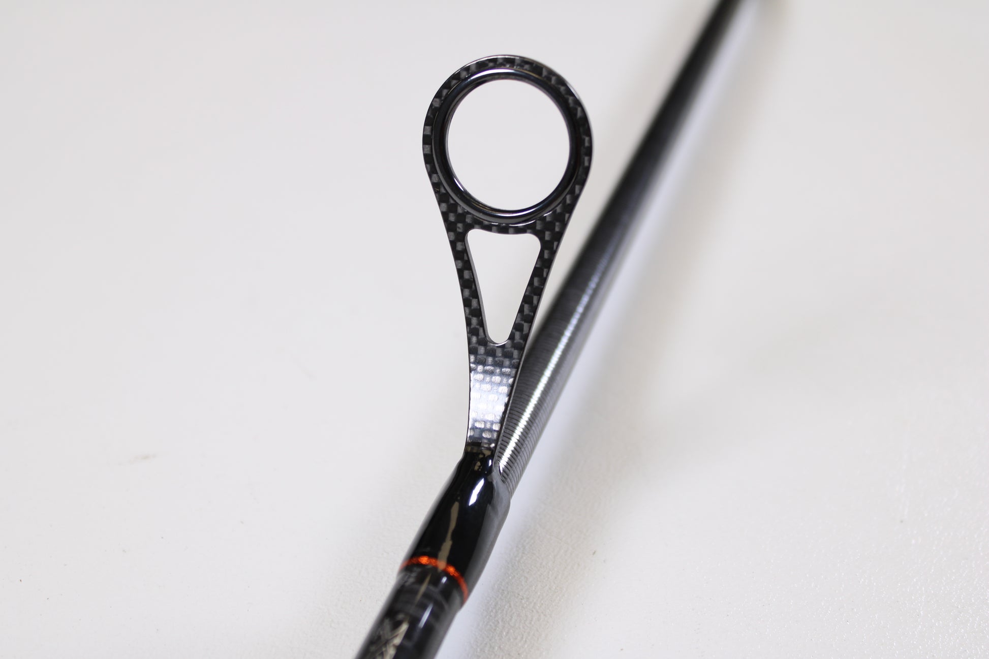 Close-up of a Daiwa Sol AGS SOLAGS76MFS 7'6" Medium spinning rod guide with black, circular frame and textured design—an excellent condition used rod, ideal for quality gear seekers or our Rod and Reel Trade-In Program.