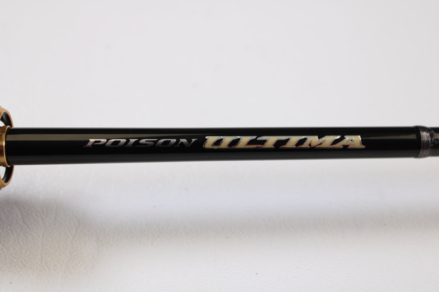 Close-up of a Shimano Poison Ultima 162L-S 6'2" Light Used Casting Rod in very good condition, with branding in metallic letters—upgrade today through our Rod and Reel Trade-In Program for store credit on your used gear.