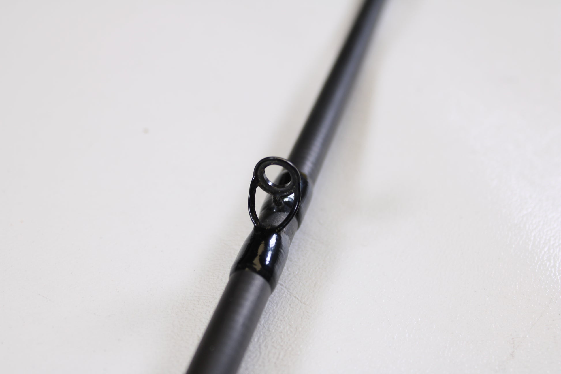 Close-up of the Shimano Intenza A NTZC72MHA 7'2" Medium Heavy Used Casting Rod’s guide, highlighting the black metal ring—ideal for anglers seeking quality used gear or trading in rods and reels for store credit.