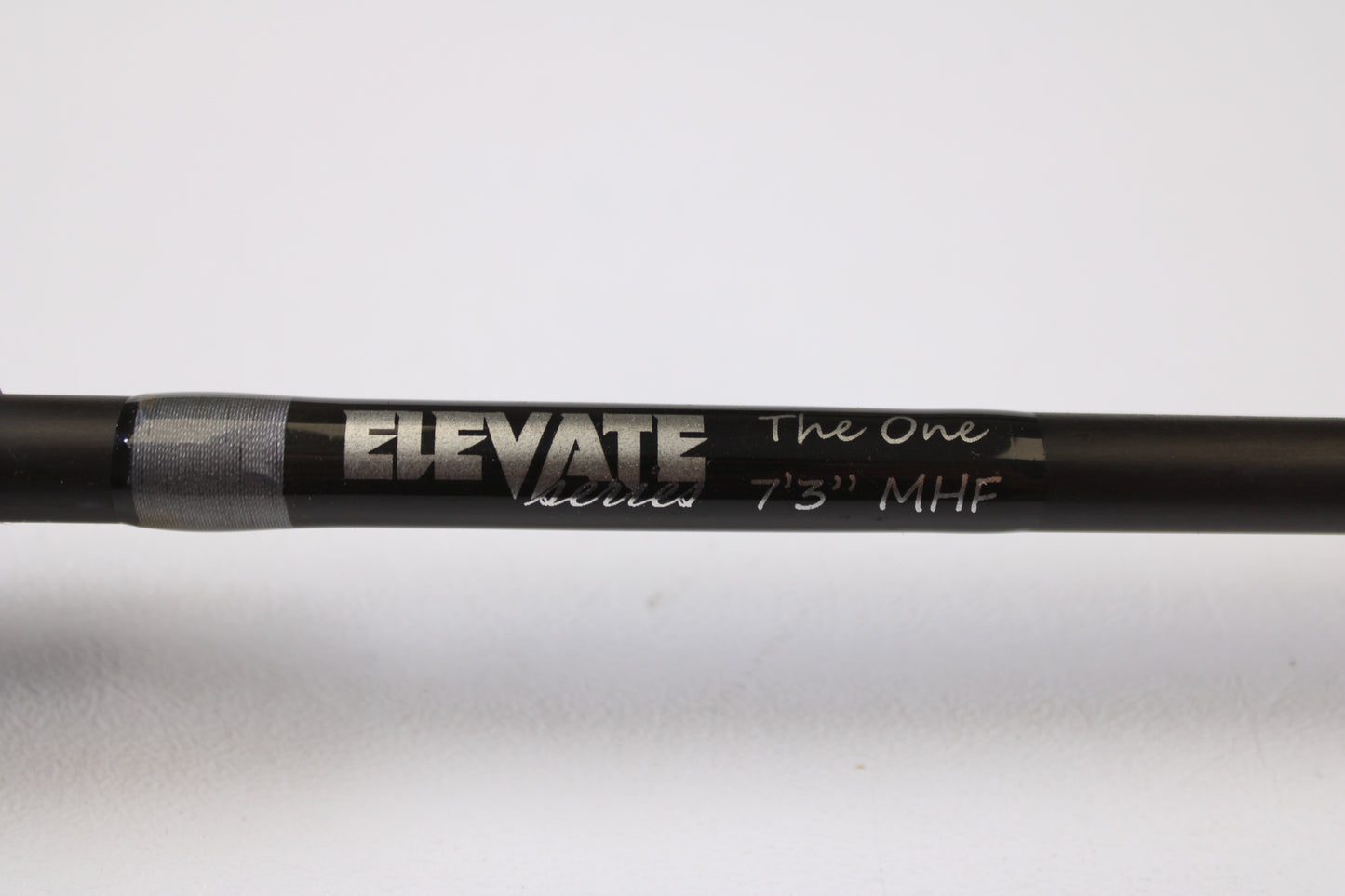 A close-up of a Stik5 Elevate Series The One 7'3" Medium Heavy used casting rod in excellent condition with silver and white text, perfect for upgrading via our rod and reel trade-in program.