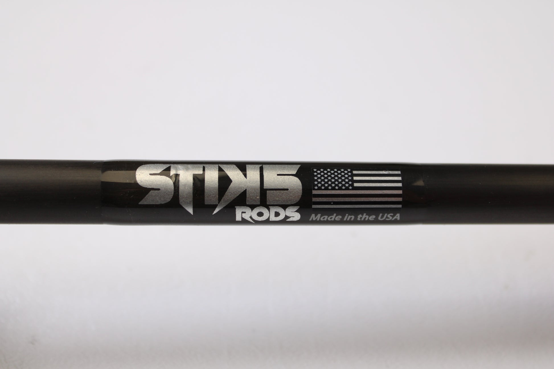 A close-up of a black Stik5 Elevate Series The One 7'3" Medium Heavy casting rod in excellent used condition, labeled "Stik5," with an American flag and "Made in the USA"—eligible for our trade-in program to earn store credit.