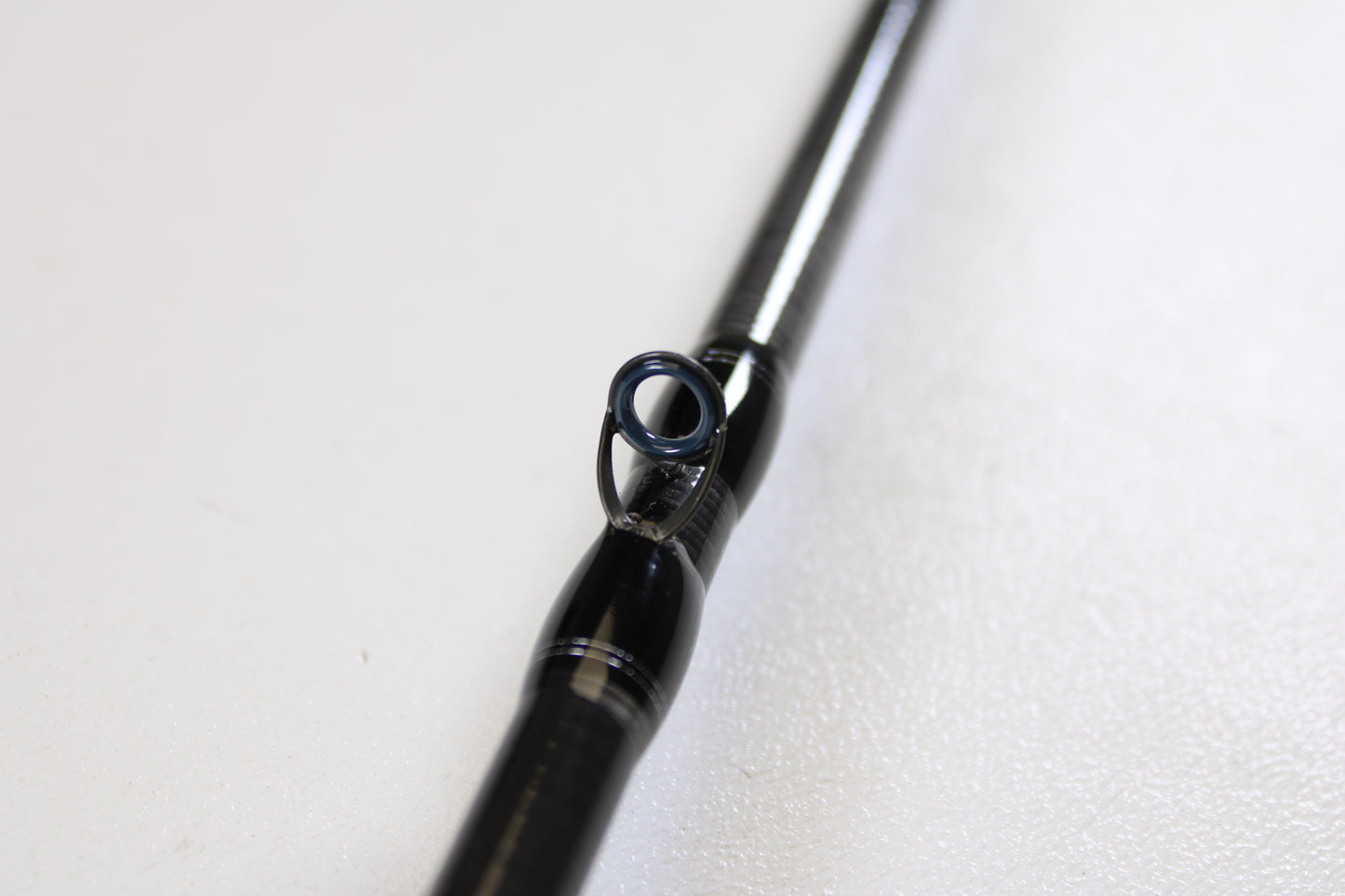 Close-up of a Daiwa Tatula TTU 731HRB-SB 7'3" Heavy Swimbait Used Casting Rod in mint condition, highlighting a line guide against a white background—perfect for trade-in customers or those seeking quality used gear.