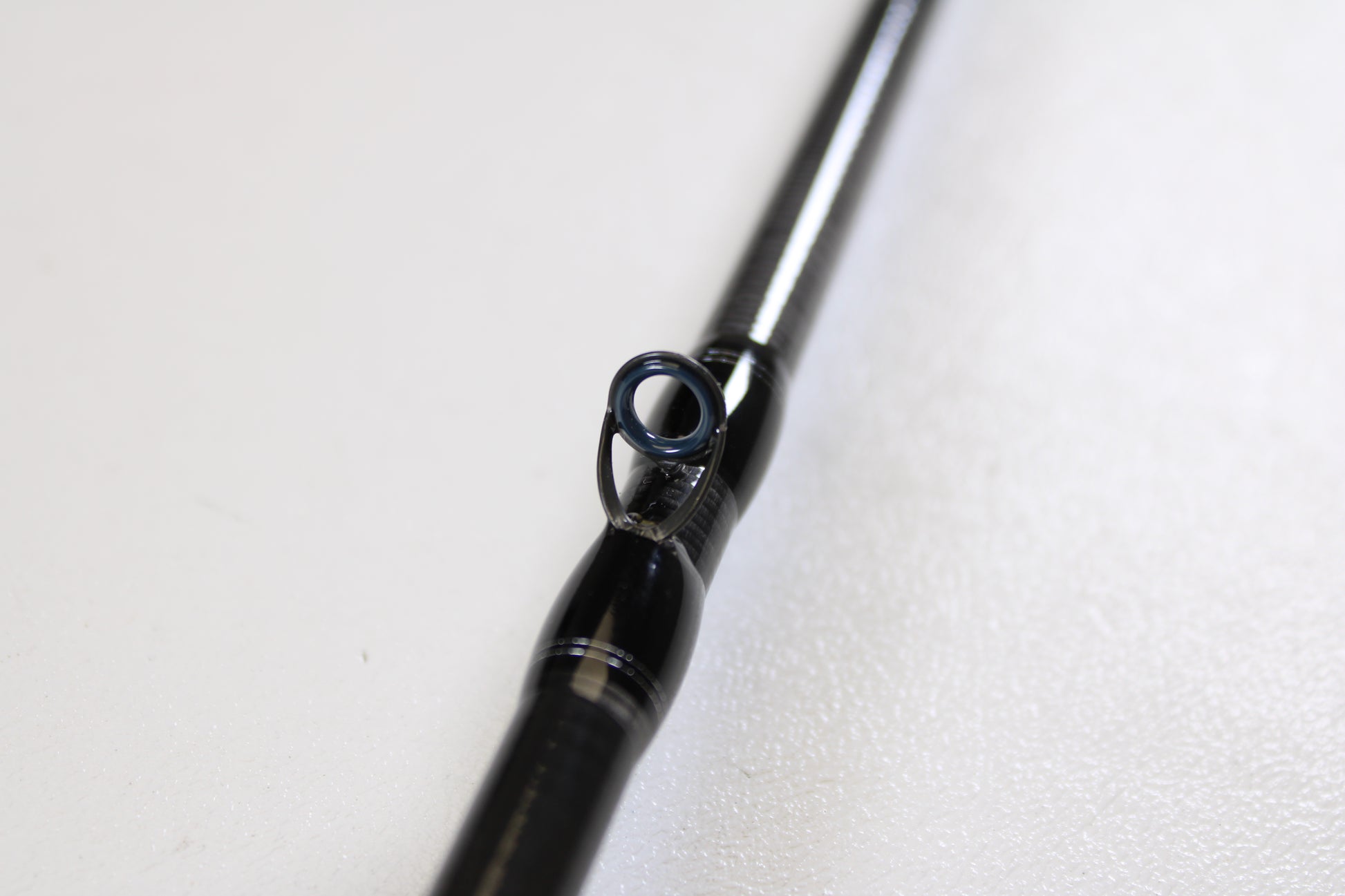 Close-up of a Daiwa Tatula TTU 731HRB-SB 7'3" Heavy Swimbait Used Casting Rod in mint condition, highlighting a line guide against a white background—perfect for trade-in customers or those seeking quality used gear.