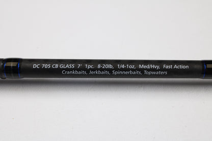 A close-up of the Dobyns Champion XP DC705CBGLASS 7'0" Medium Heavy Glass Casting Rod (Used, Excellent Condition) shows specs in white on black—trade up with our Rod and Reel Trade-In Program for store credit on your next Dobyns purchase.