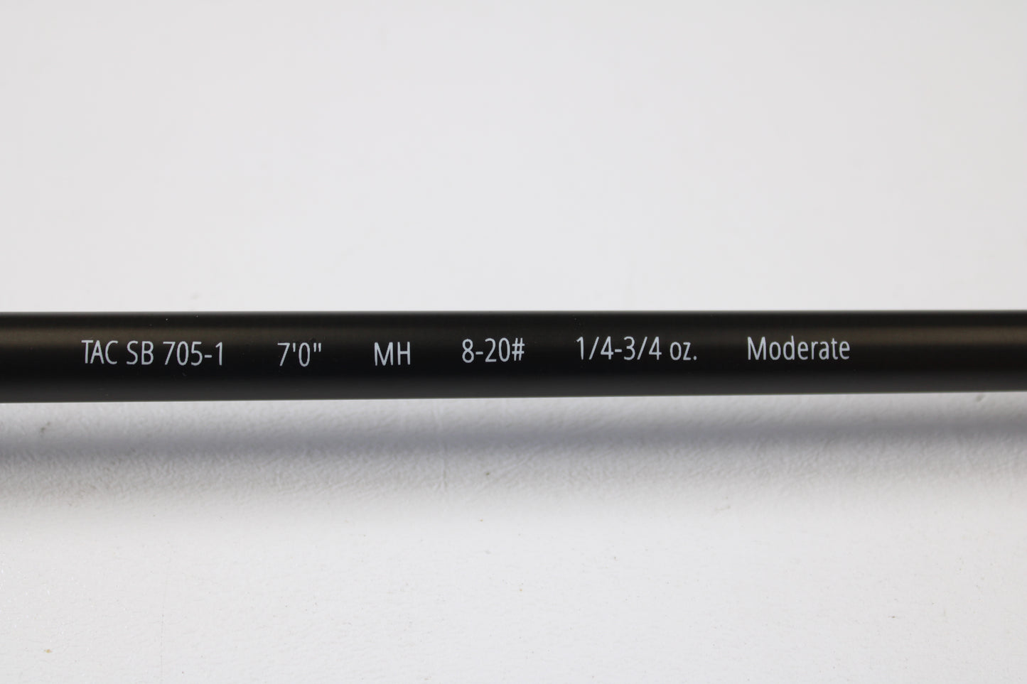 A close-up of the Temple Fork TFO Tactical Bass TACSB7051-3 7'0" Medium Heavy Casting Rod (used, excellent) highlights its features—ideal for anglers trading up through our Rod and Reel Trade-In Program.