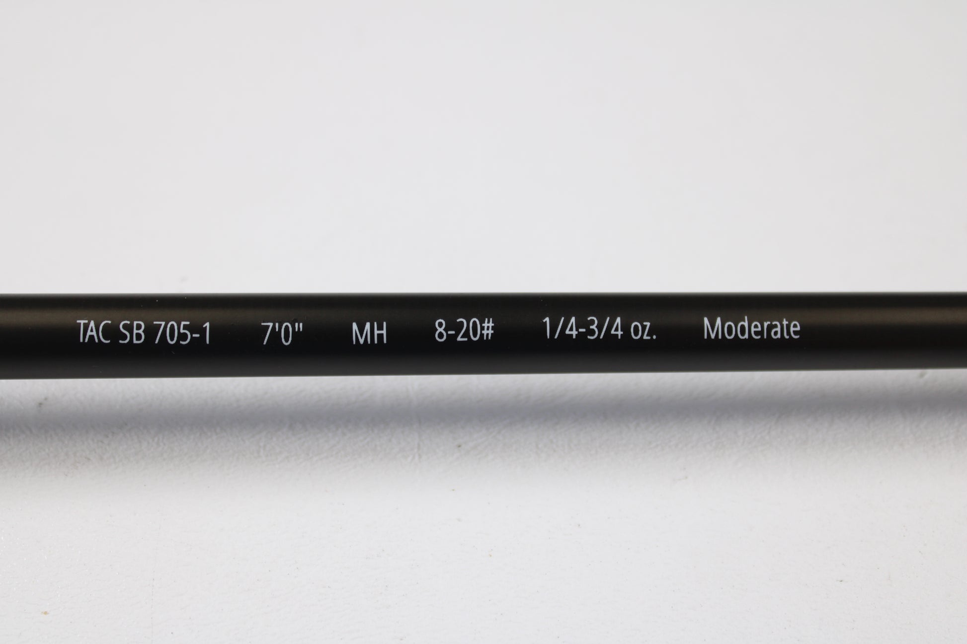 A close-up of the Temple Fork TFO Tactical Bass TACSB7051-3 7'0" Medium Heavy Casting Rod (used, excellent) highlights its features—ideal for anglers trading up through our Rod and Reel Trade-In Program.