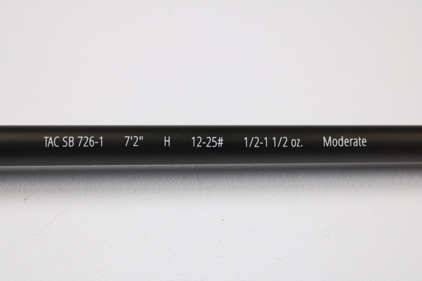 Close-up of a Temple Fork TFO Tactical Bass TACSB726-1 7'2" Heavy used casting rod in excellent condition, displaying its specs on the blank. Great for anglers seeking quality used gear or our rod and reel trade-in. Photographed on white background.