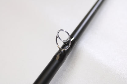 Close-up of a Temple Fork TFO Tactical Bass TACSB726-1 7'2" Heavy used casting rod in excellent condition, highlighting the metal guide ring—perfect for anglers interested in quality pre-owned gear or our trade-in program.