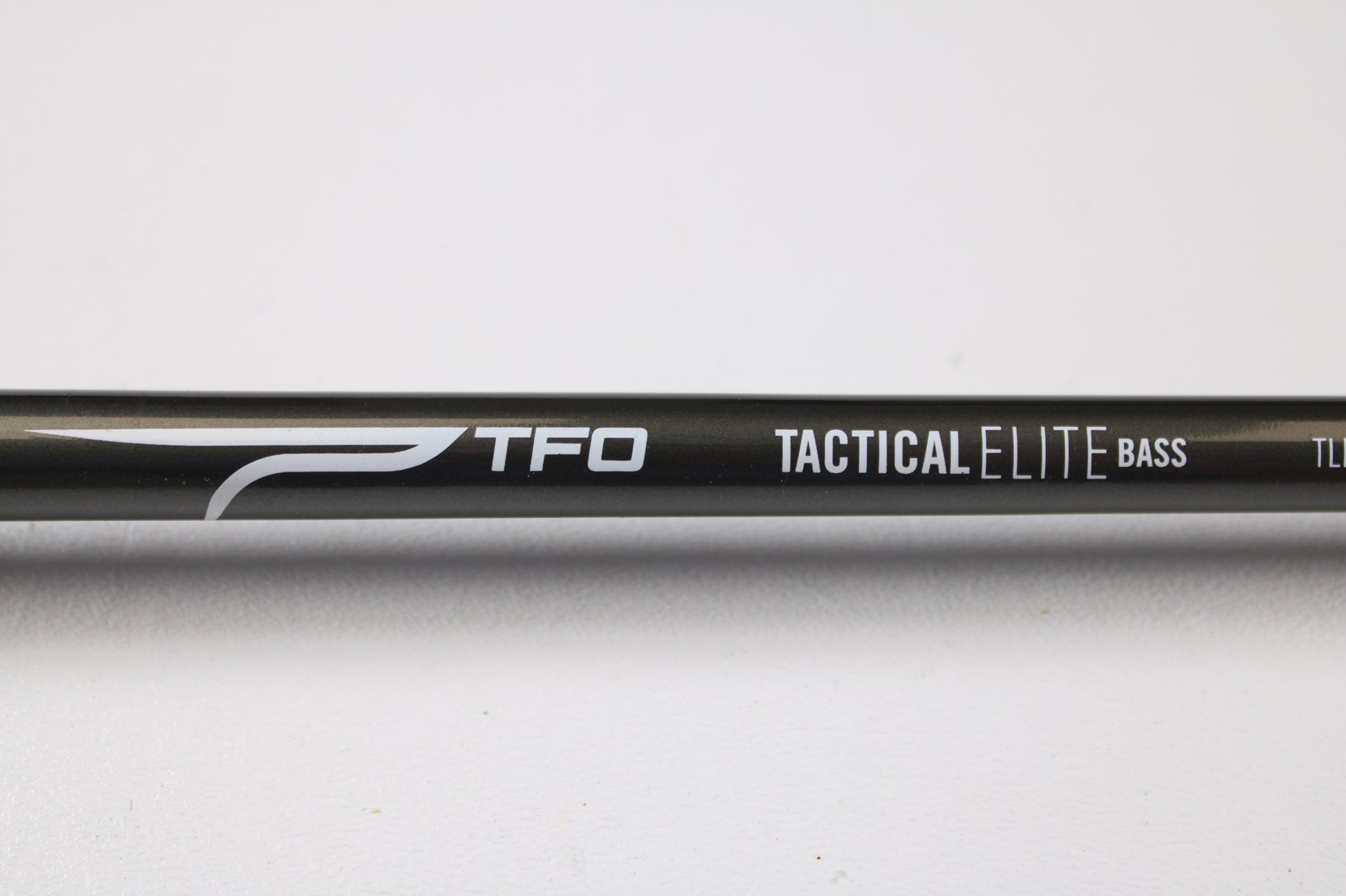 A close-up of a Temple Fork TFO Tactical Elite Bass TLE SC 747-1 7'4" Ex-Heavy Used Casting Rod in excellent condition—ideal for anglers seeking quality used rods or those interested in our rod and reel trade-in program.