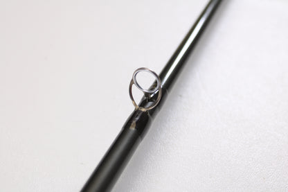 A close-up of the Temple Fork TFO Tactical Elite Bass TLE SC 747-1 7'4" Ex-Heavy Used Casting Rod in excellent condition, featuring a metal guide ring, photographed on a plain white surface.
