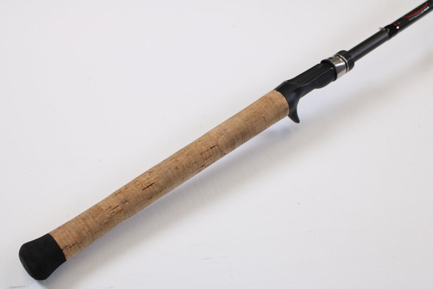 A close-up of the Kistler KFGS73 Frog and Slop Special 7'3" Heavy Used Casting Rod handle—featuring a cork grip and black reel seat—ideal for customers interested in our Rod and Reel Trade-In Program for store credit.