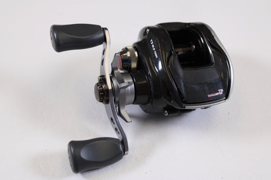 The Daiwa T3 Ballistic 6.3:1 RH Used Casting Reel in good condition features two ergonomic handles and silver accents—ideal for saving with our Rod and Reel Trade-In Program or earning store credit for used gear.
