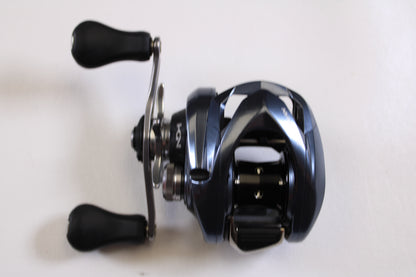 A close-up of the Shimano Aldebaran MGL ALDMGL51 6.5:1 LH Used Casting Reel in very good condition, featuring two black handles—ideal for upgrading as part of our Rod and Reel Trade-In Program.