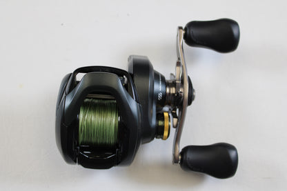 The Shimano Curado 200 K CU200HGK 7.4:1 RH Used Casting Reel—shown in excellent condition with green line spooled—is ideal for rod and reel trade-ins or those seeking top-quality pre-owned Shimano gear.