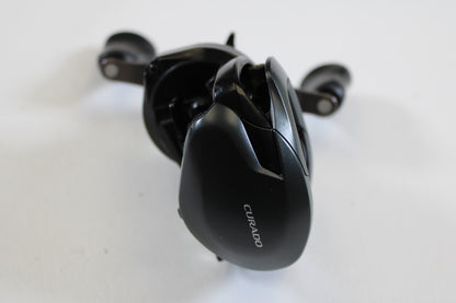 A close-up of a Shimano Curado 200 K CU200HGK 7.4:1 RH casting reel in excellent used condition, ideal for anglers upgrading with our rod and reel trade-in program.