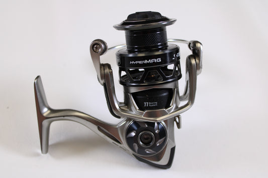 A close-up of a Lew's HyperMag HMS200 6.2:1 used spinning reel in fair condition (missing handle nut), with silver and black accents, shown on a white background—ideal for our rod and reel trade-in program for store credit.