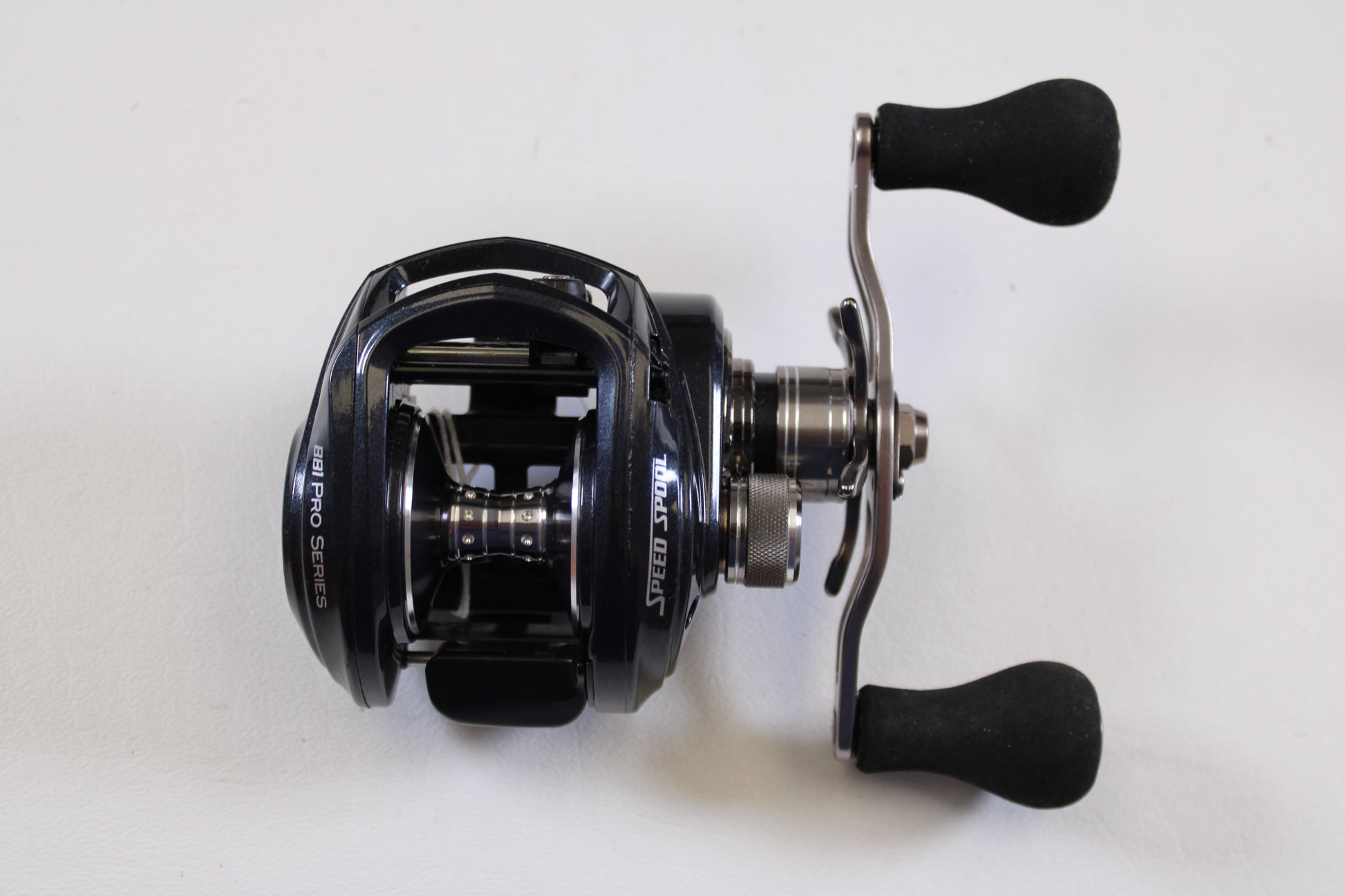 The Lew's BB1 Pro PRS1HZ 6.4:1 RH - Used Casting Reel, in excellent condition, features dual handles and a sleek black metallic finish—perfect for our Rod and Reel Trade-In Program or your used gear collection. Displayed on a white background.