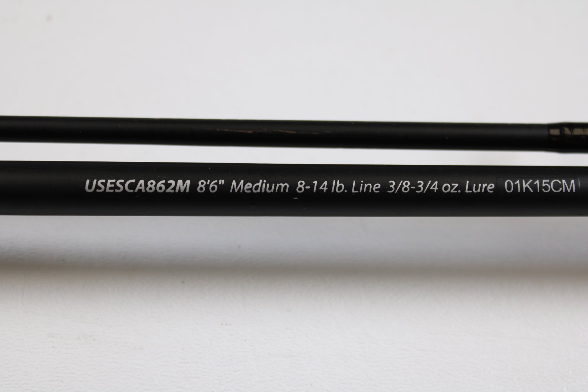 A close-up of the Shakespeare Ugly Stik Elite Salmon/Steelhead USESCA862M 8'6" Medium 2 Piece casting rod (Qty: 2, used, excellent condition)—ideal for our Rod and Reel Trade-In Program or used gear store credit.