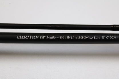 A close-up of the Shakespeare Ugly Stik Elite Salmon/Steelhead USESCA862M 8'6" Medium 2 Piece casting rod (Qty: 2, used, excellent condition)—ideal for our Rod and Reel Trade-In Program or used gear store credit.
