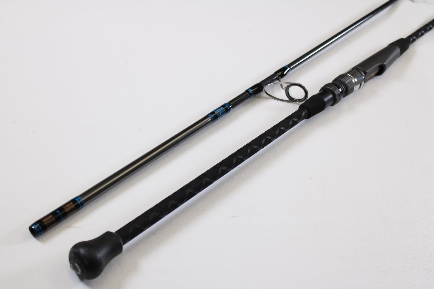 A close-up of the Tsunami Airwave Elite TSAWESS762LT 7'6" 2-piece used spinning rod in excellent condition, highlighting its textured handle and components—ideal for anglers seeking quality pre-owned gear or trade-in options.