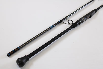A close-up of the Tsunami Airwave Elite TSAWESS762LT 7'6" 2-piece used spinning rod in excellent condition, highlighting its textured handle and components—ideal for anglers seeking quality pre-owned gear or trade-in options.