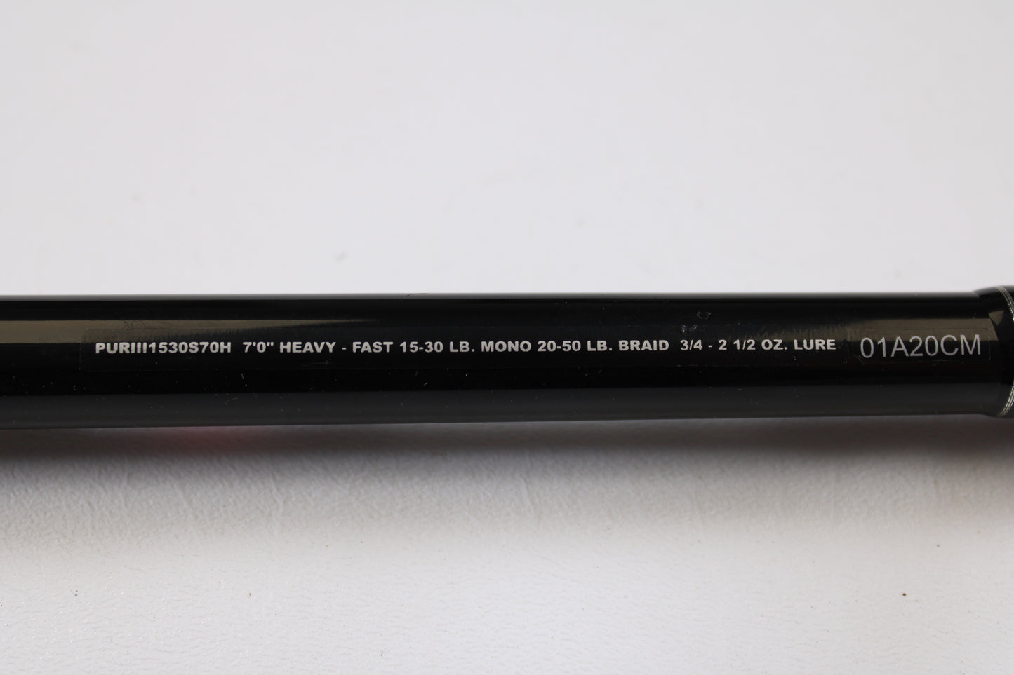 A close-up of the Penn Pursuit III PUTIII1530S70H 7'0" Heavy Used Spinning Rod (excellent condition) shows specs: "7’0’’ HEAVY - FAST 15-30 LB. MONO 20-50 LB. BRAID 3/4 - 2 1/2 OZ. LURE," ideal for trade-in or used gear shoppers.