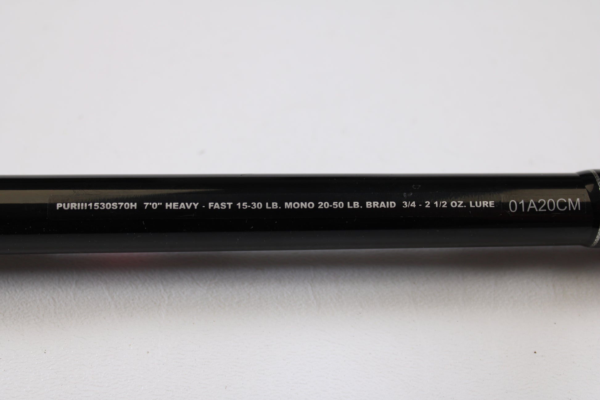 A close-up of the Penn Pursuit III PUTIII1530S70H 7'0" Heavy Used Spinning Rod (excellent condition) shows specs: "7’0’’ HEAVY - FAST 15-30 LB. MONO 20-50 LB. BRAID 3/4 - 2 1/2 OZ. LURE," ideal for trade-in or used gear shoppers.