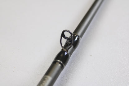 Close-up of the Fenwick Elite Bass ELTB70MH-FC 7'0" Medium Heavy Casting Rod (Used, Very Good Condition) guide ring on a grey rod, set against a white background—ideal for those upgrading with our Trade-In Program.