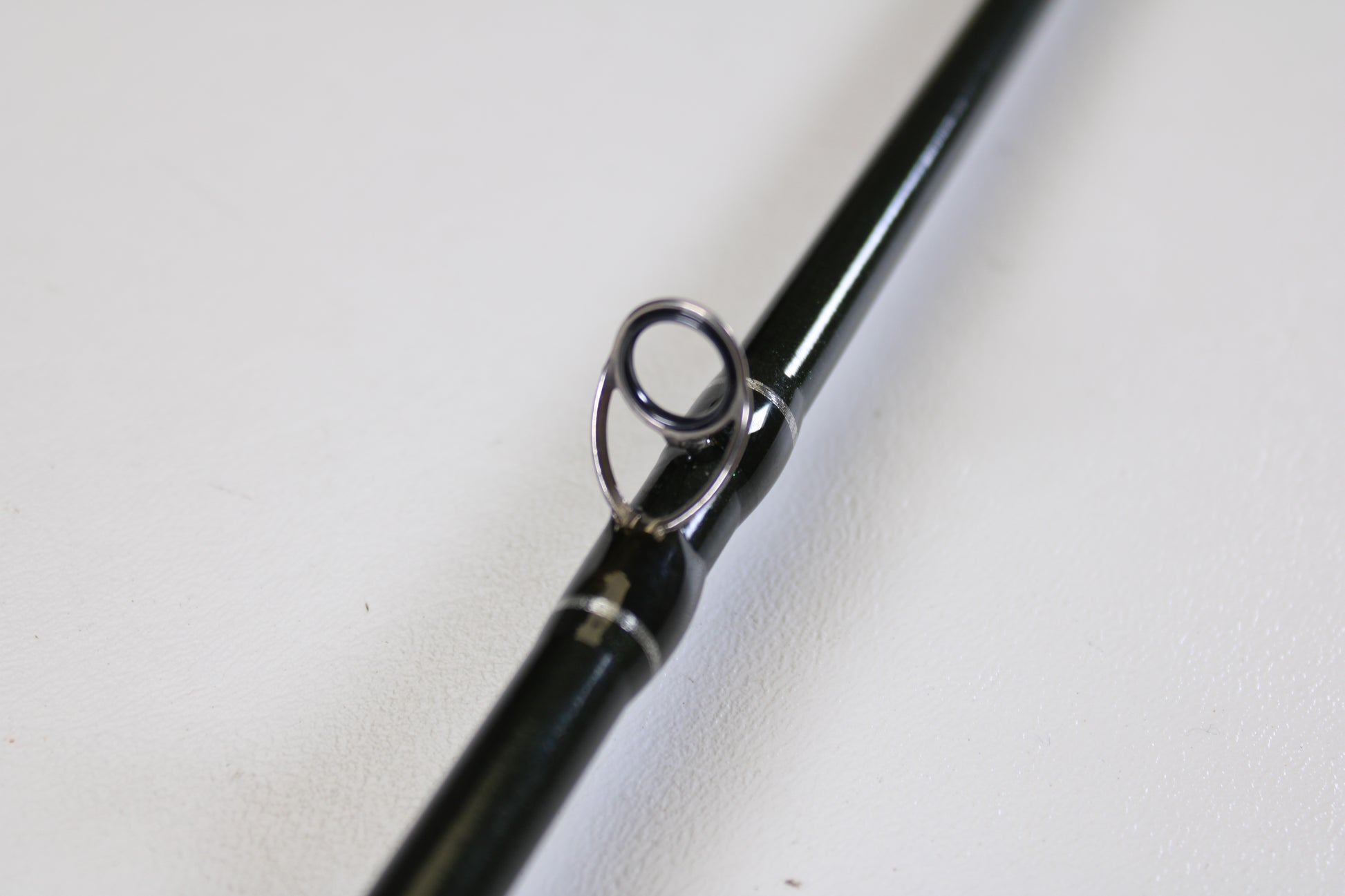 Close-up of a St. Croix Legend Elite EC70MF 7'0" Medium Used Casting Rod in excellent condition, highlighting a metal guide loop. Available through our Rod and Reel Trade-In Program for store credit. Plain white background.