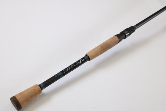 A close-up of the Vocelka Tournament Series The Spinnin' Rod 7'1" Medium Light, a used spinning rod in excellent condition, ideal for upgrading via our Rod and Reel Trade-In Program, shown against a plain white background.