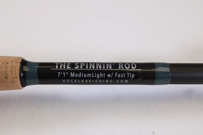 Close-up of a Vocelka Tournament Series The Spinnin' Rod 7'1" Medium Light (Used, Excellent Condition) against a white background with part of the cork handle visible—ideal for our Rod and Reel Trade-In Program.
