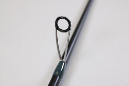 Close-up of the Vocelka Tournament Series The Spinn' Rod 7'1" Medium Light guide, showing its ring and support on a plain background. Ideal for those interested in trading or earning store credit with used Vocelka gear.