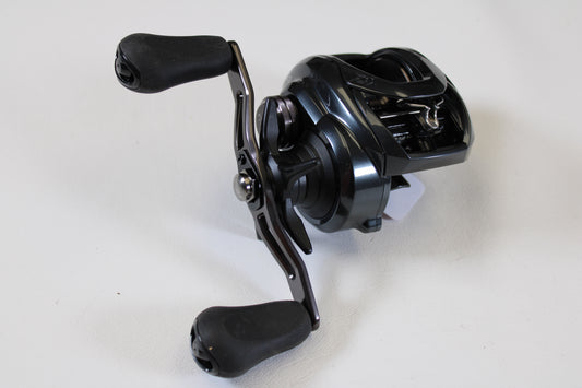 A close-up of a Daiwa Tatula 300 TTU300P 5.3:1 RH used casting reel in excellent condition with two ergonomic handles—ideal for upgrading through our rod and reel trade-in program.