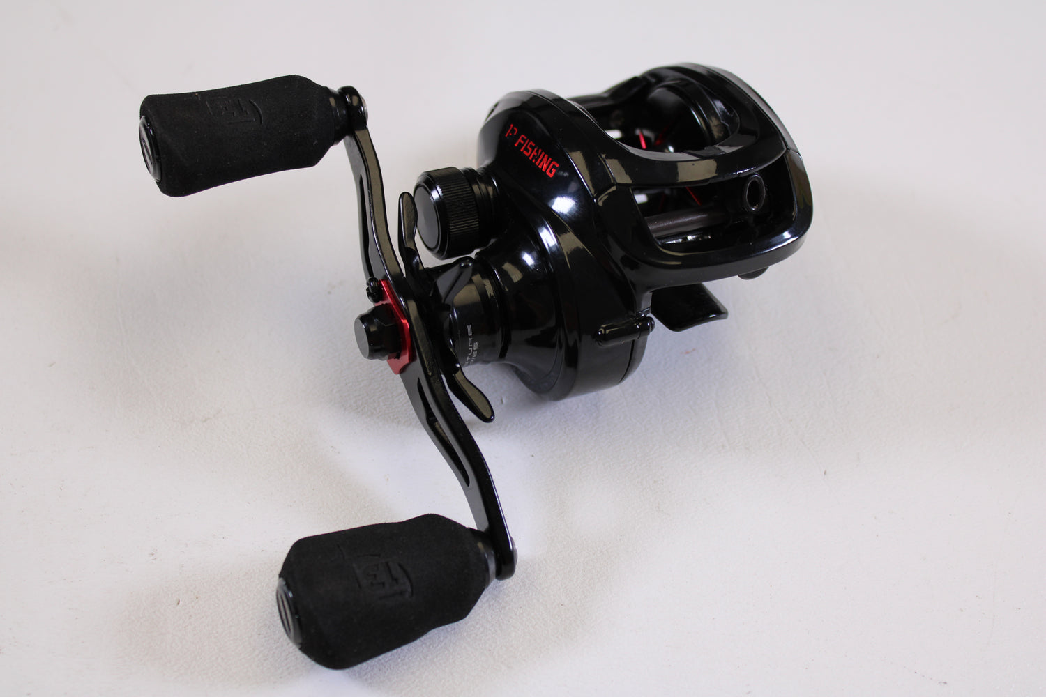 A used 13 Fishing Inception G2P ING2P-5.3-RH casting reel in excellent condition, with two padded handles and metallic accents—trade in your old gear for store credit through our Rod and Reel Trade-In Program.