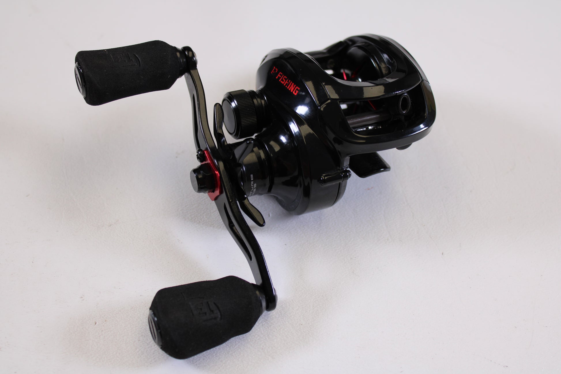 A used 13 Fishing Inception G2P ING2P-5.3-RH casting reel in excellent condition, with two padded handles and metallic accents—trade in your old gear for store credit through our Rod and Reel Trade-In Program.
