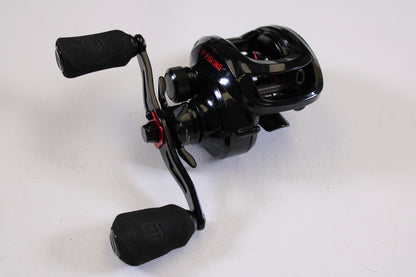 A used 13 Fishing Inception G2P ING2P-5.3-RH casting reel in excellent condition, with two padded handles and metallic accents—trade in your old gear for store credit through our Rod and Reel Trade-In Program.