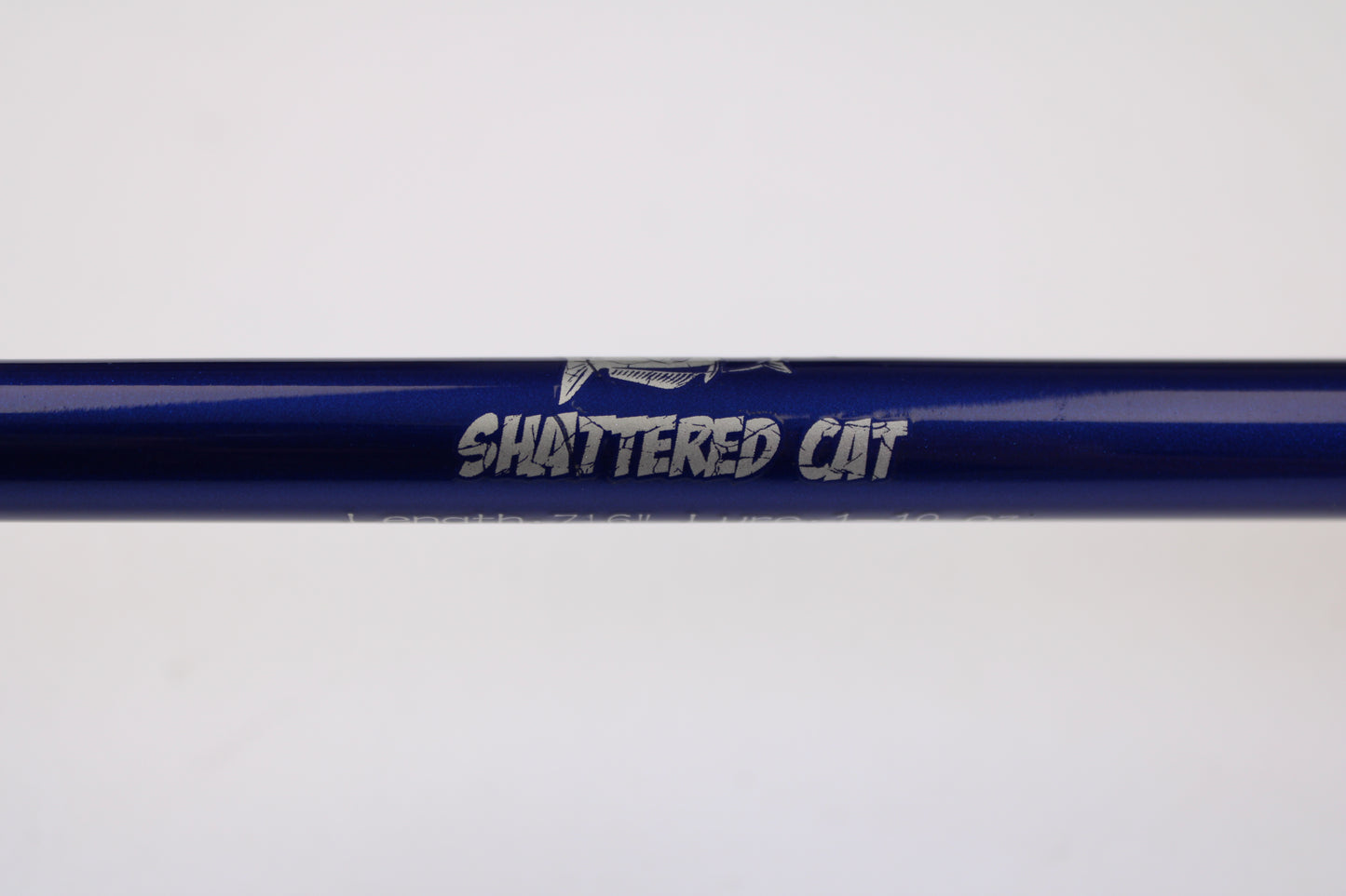 A close-up of the Shattered Cat 7'6" Heavy Used Casting Rod in excellent condition, featuring "SHATTERED CAT" in silver and a graphic above the text—ideal for those interested in used rods or our gear trade-in program.